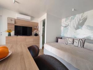 a living room with a bed and a dining table at Zen Zone Premium Mobile Home in Drage