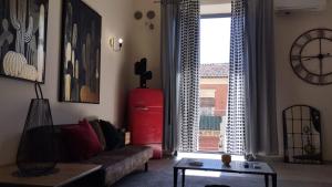 a living room with a couch and a red refrigerator at INDUSTRY HOME in Catania