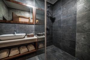 a bathroom with a sink and a mirror at Apartments and Rooms Villa Majestic in Bihać