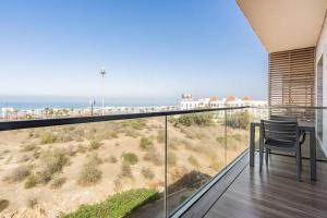 a balcony with a table and a view of the beach at Sublime Appart sur la Corniche , Luxueux et Vue sur Mer in Casablanca