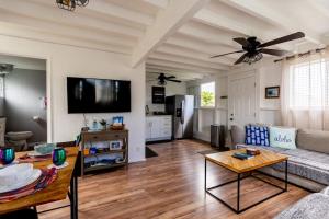 a living room with a couch and a table at Somewhere over the Rainbow Loft with AC Hilo in Hilo