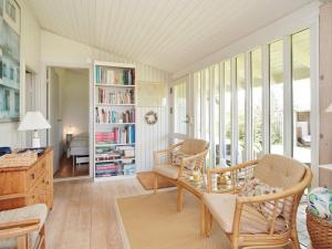 a living room with a couch and a table and chairs at 6 person holiday home in Jægerspris-By Traum in Jægerspris