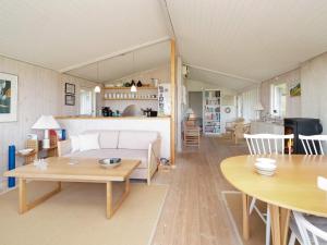 a living room with a couch and a table at 6 person holiday home in Jægerspris-By Traum in Jægerspris