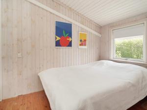 a bedroom with a white bed and a window at 6 person holiday home in Jægerspris-By Traum in Jægerspris