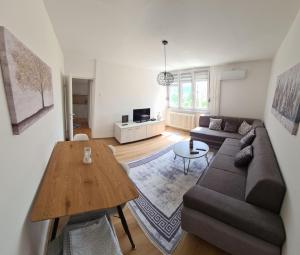 a living room with a couch and a table at Bilino polje in Zenica
