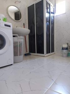 a bathroom with a washing machine and a sink at Marmaristeki Eviniz 