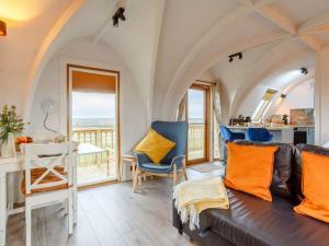 a living room with a couch and a table and chairs at Caithness View Luxury Farm Lodges and BBQ Huts in Wick