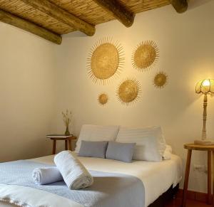 a bedroom with a bed with three mirrors on the wall at Hotel Casa Boutique Villa de Leyva in Villa de Leyva