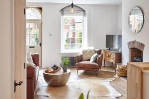 a living room with two chairs and a table at Boutique Fisherman’s Cottage in Cullercoats