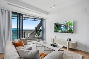 a living room with a couch and a table at Jewel Beachfront Residences in Gold Coast