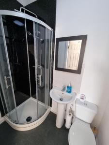 a bathroom with a shower and a toilet and a sink at PL Liverpool in Liverpool