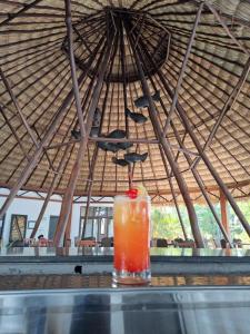 a drink sitting on top of a table in a tent at Maya Internacional in Flores