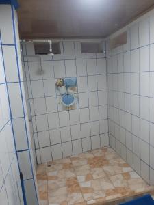 a tiled shower with a dog sitting on the floor at House la Rose Second Floor in Manuel Antonio