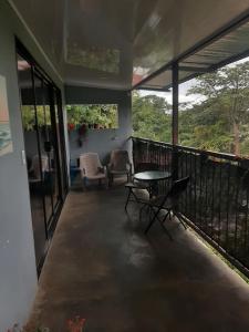 a balcony of a house with a table and chairs at House la Rosa third floor 5 in Quepos