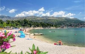 a group of people on a beach in the water at Romantic Escape With Private Hot Tub Near Split in Žrnovnica