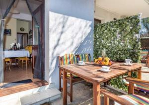 a wooden table with fruit on a patio at Apartments with a parking space Selce, Crikvenica - 5477 in Selce