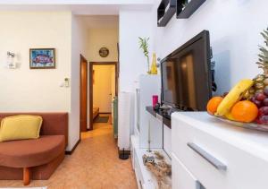 a living room with a flat screen tv on a counter at Apartments with a parking space Selce, Crikvenica - 5477 in Selce