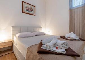 a bedroom with a bed with towels on it at Apartments with a parking space Selce, Crikvenica - 5477 in Selce