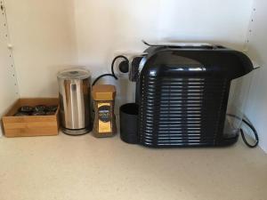a black toaster sitting on top of a kitchen counter at Griffin Getaway in Orange
