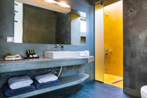 a bathroom with a sink and a mirror at Alekos Beach Houses-Profilio's Villas in Lixouri +25 photos