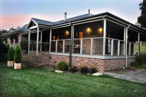 a home with a brick house with a yard at Meriba B and B in Bundanoon