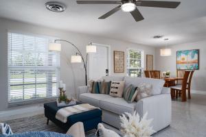 a living room with a couch and a ceiling fan at 5027 Fairfield DR - Paradise Palms home in Fort Myers