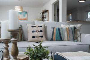 a living room with a white couch with pillows at 5027 Fairfield DR - Paradise Palms home in Fort Myers