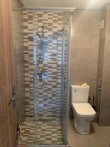 a shower in a bathroom with a toilet at Oceanica by Smir Park in M'diq
