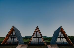 a group of triangular buildings with a blue sky in the background at TITA HOMES in Tʼelavi
