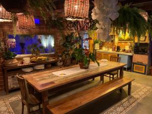 a kitchen with a wooden table with plants on it at Villa Lulu Geribá in Búzios