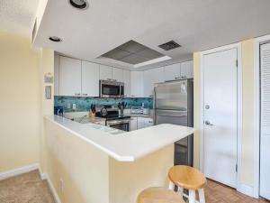 a kitchen with white cabinets and a white counter top at 1B/1B condo with Ocean views, Resort style, Free WIFI, Few steps to the Beach!! in Wildwood Crest