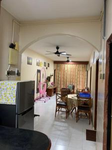 a kitchen and living room with a table and chairs at SERI LAGENDA APARTMENT 3 in Kuah +23 photos