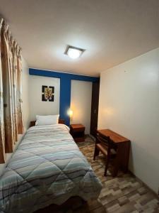 Postel nebo postele na pokoji v ubytování Hostal Inkanto Taruma