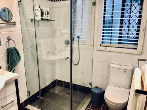 a bathroom with a shower with a toilet and a sink at Hotel Style Monterey Guest Studio near Hospitals, Beach and Airport in Sydney