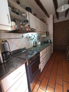 a kitchen with a stove top oven in a room at Habitación privada cerca del centro in Godoy Cruz