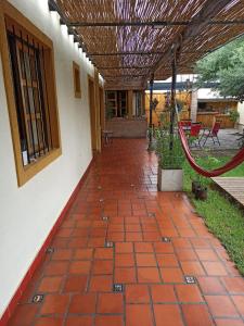 a patio with a red brick floor and a building at Habitación privada cerca del centro in Godoy Cruz