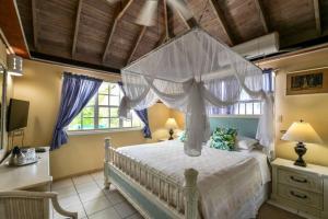 a bedroom with a bed with a canopy at Little Rock Cottage in Cobbs Cross