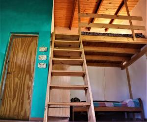 a ladder leading up to a bunk bed in a room at Colibrí Apart in El Soberbio