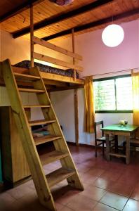 a room with a bunk bed and a table at Colibrí Apart in El Soberbio