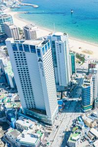 釜山にあるLavi De Atlan Hotel 2の海辺と建物のある街の空中を望む