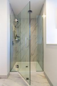 een douche met een glazen deur in de badkamer bij Inner City Luxury 2 Bedroom 2 Bathroom in Christchurch