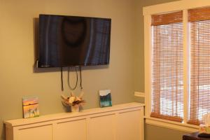 a flat screen tv on a wall in a living room at The Hillside B&B. Home w/ Breakfast Service! in Wisconsin Dells