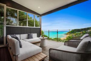 a living room with a view of the ocean at Elouera in Byron Bay