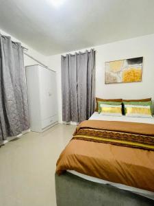 a bedroom with a large bed and curtains at Z House of Guest- Airport Davao in Davao City