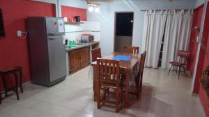 a kitchen with a table and a refrigerator at Lo de La Abuela 1 in Goya