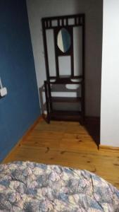 a room with a bed and a chair with a mirror at Lo de La Abuela 1 in Goya +9 photos