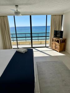 a bedroom with a bed and a view of the ocean at Two Bedroom Ocean View Penthouse at Pelican Sands in Gold Coast