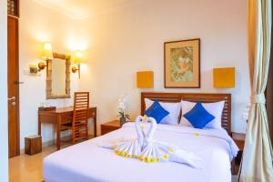 Postel nebo postele na pokoji v ubytování Starloka Saba Bali Hotel