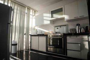 a kitchen with a stainless steel stove and a window at Moderna casa con equipamiento completo! in Ica