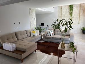 a living room with a couch and a table at Casa Malta - St Sul in Goiânia